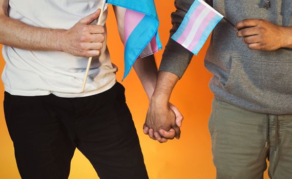 couple-holding-hands-with-trans-pride-flags.jpg