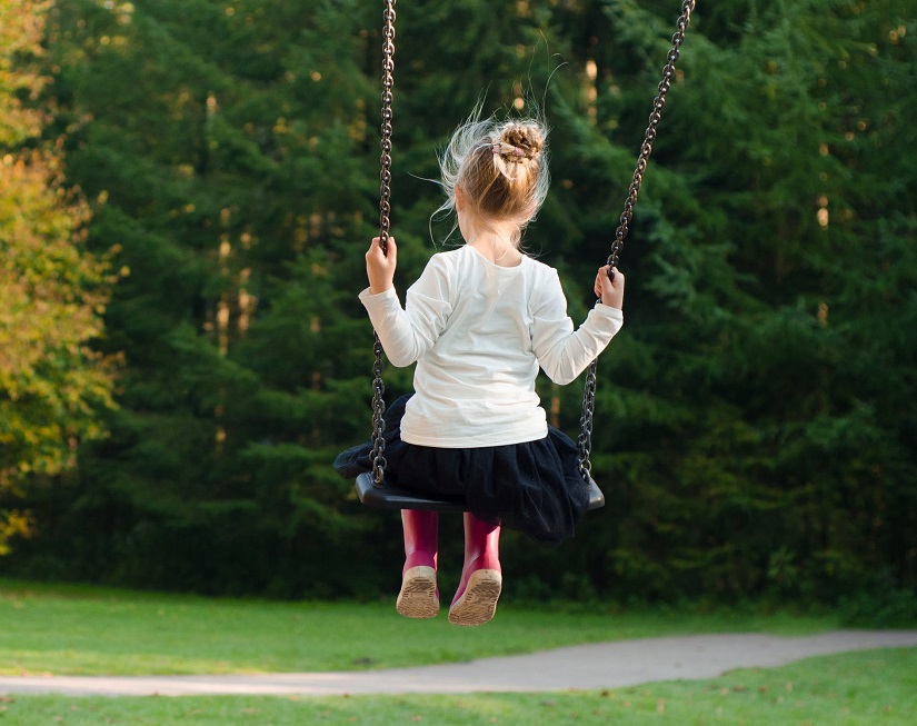 young girl swinging
